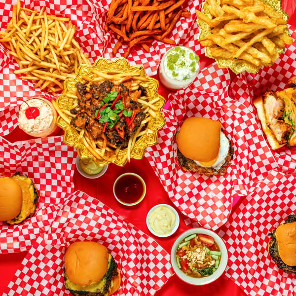 Overhead view of Ban Ban Burger's spread, including burgers, fries, milkshakes, and chili cheese fries.